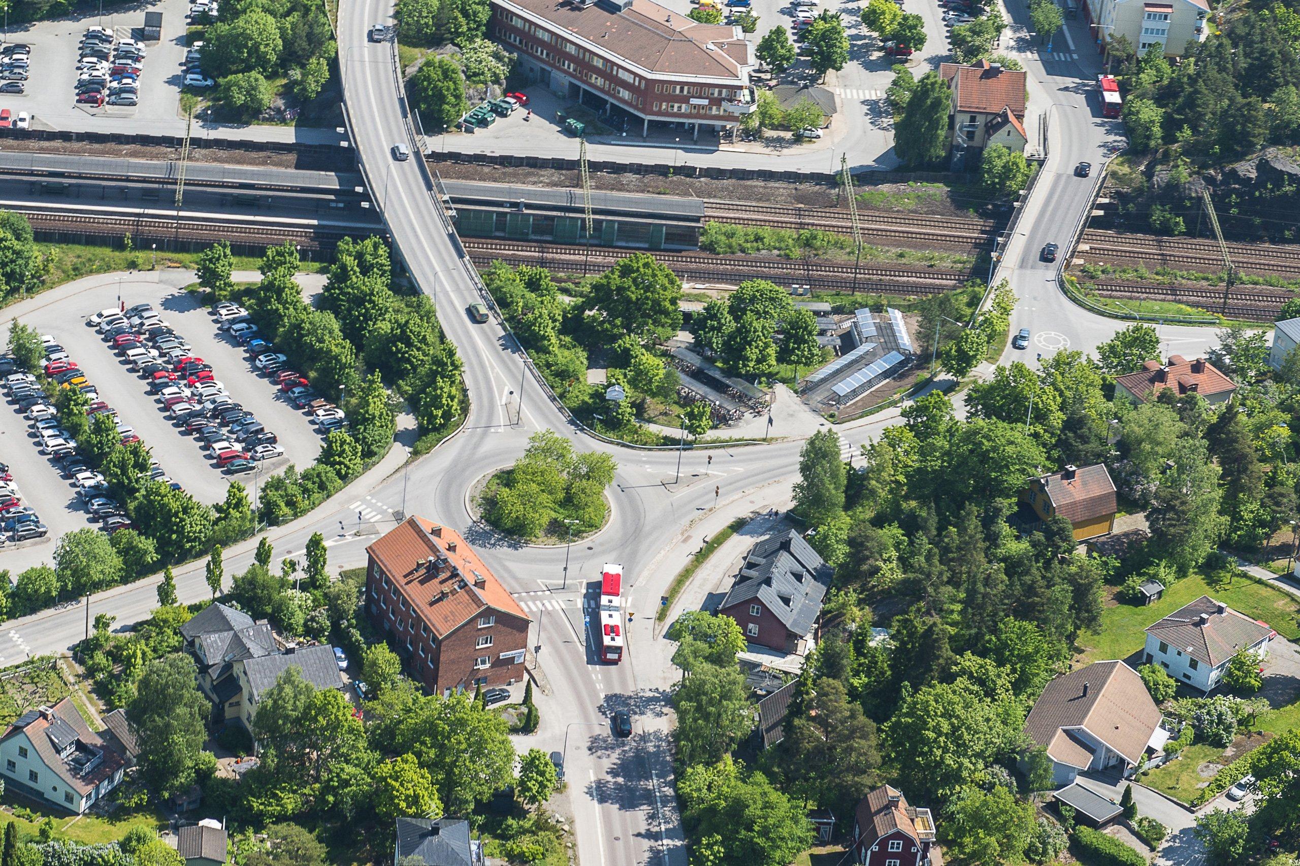 Flygbild över Stuvsta centrum med pendeltåg och parkering.